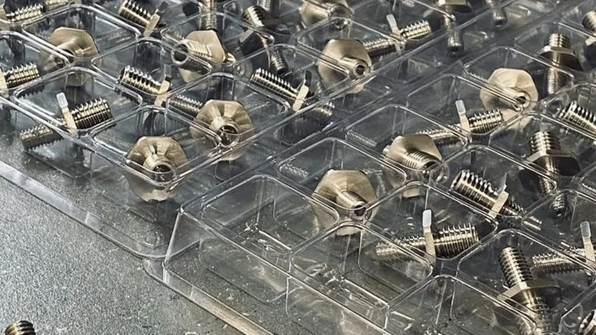 Small Swiss-turned brass pins, inserts and precision parts in inspection trays