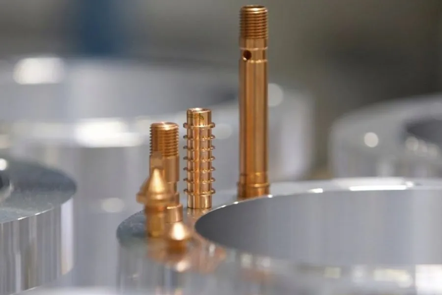 Copper turned pins and inserts on a Brassland CNC machine