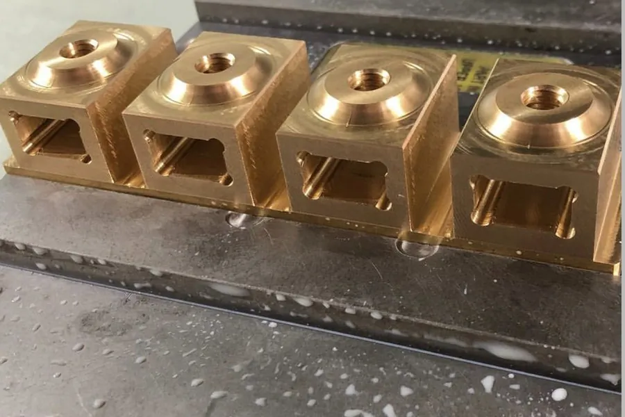 Multi-cavity brass terminal bodies being milled at Brassland