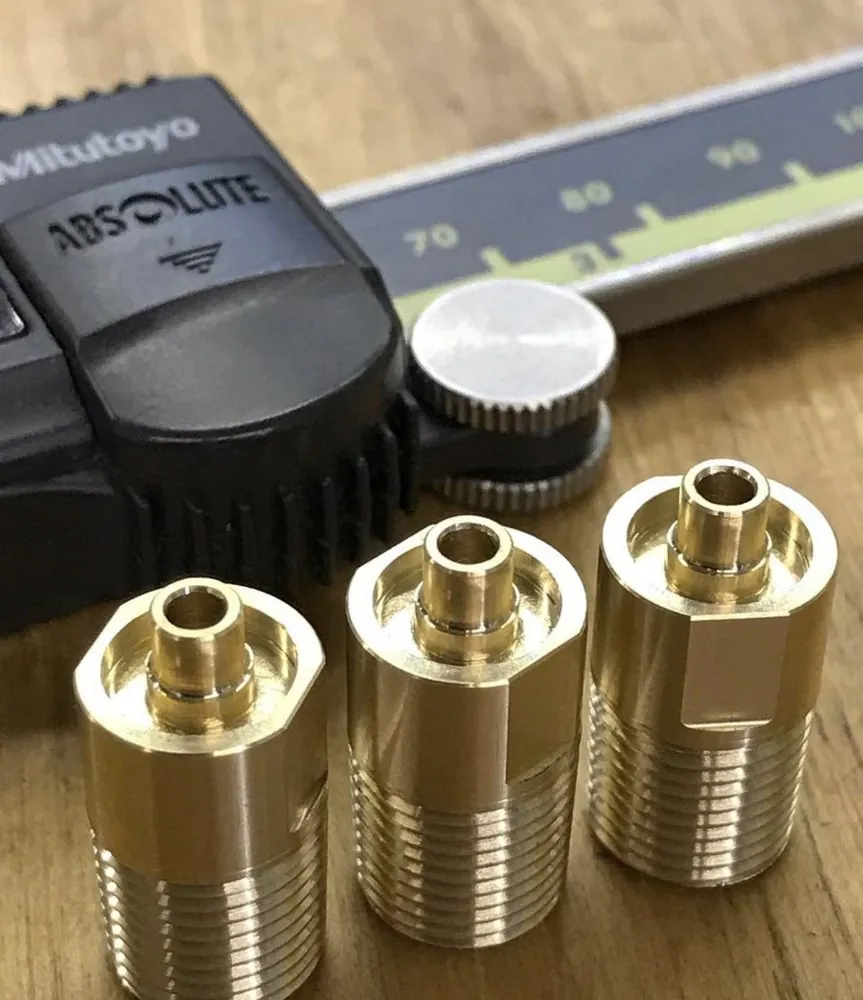 Brass fittings checked with a Mitutoyo caliper during inspection
