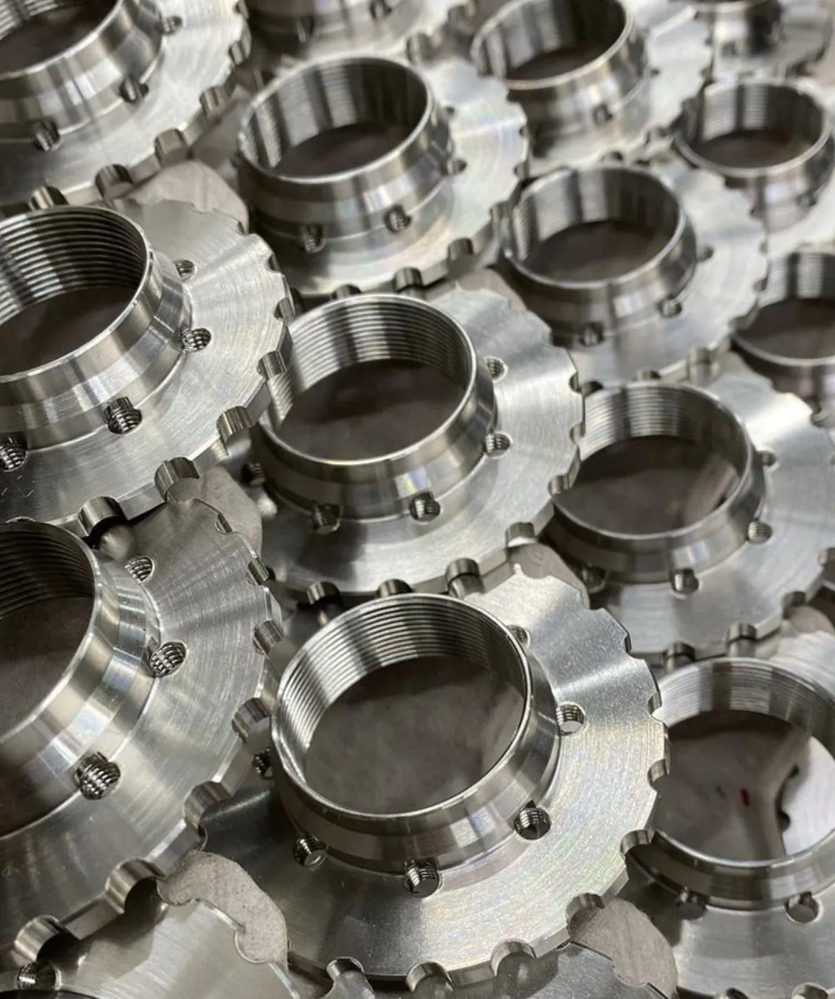 Rows of machined brass flanged components
