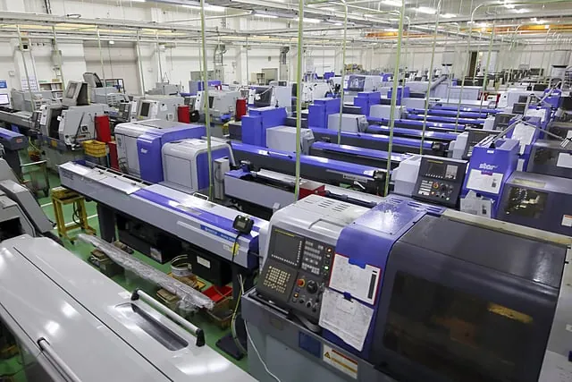 Brassland CNC machining floor — rows of precision Tsugami / Citizen Swiss-type CNC lathes, Jamnagar India