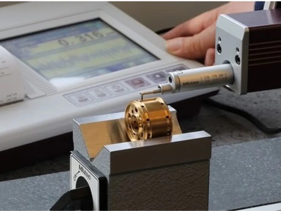 Mitutoyo Surftest surface roughness tester measuring Ra on a machined brass part at Brassland