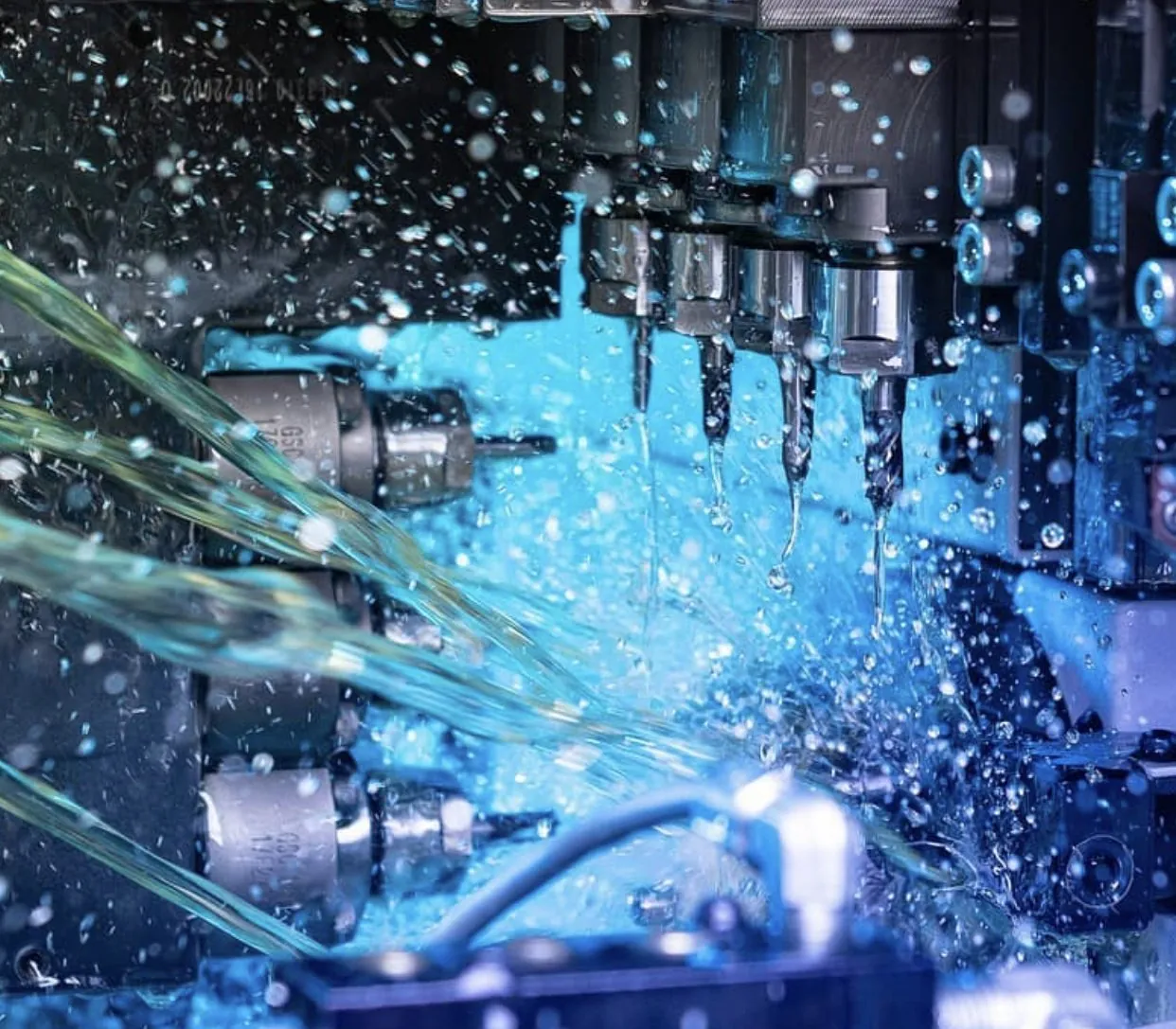 Coolant spraying over cutting tools inside a CNC turning centre at Brassland